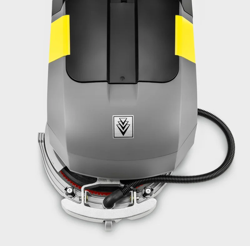 Kärcher Bodenreinigungsmaschine mit grauem Gehäuse und gelben Akzenten, Draufsicht.