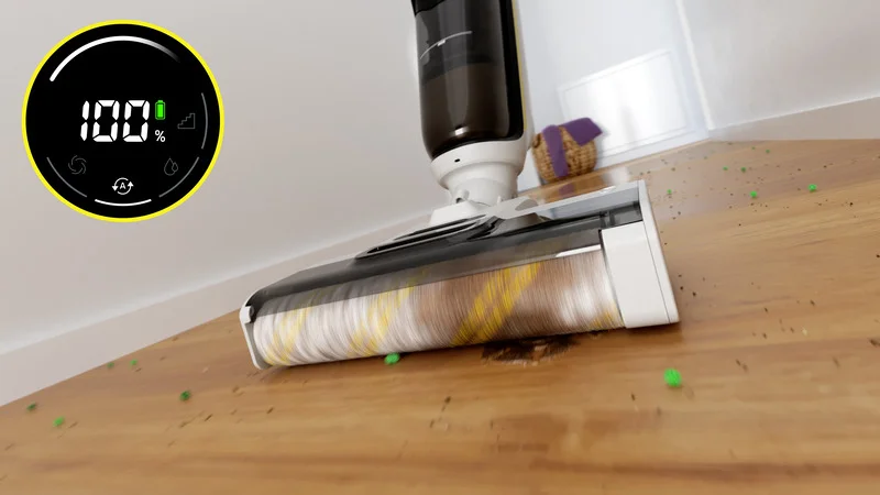 Kärcher Bodenreiniger auf Holzfußboden, entfernt Schmutz und grüne Partikel. Anzeige zeigt 100% Batteriestand.